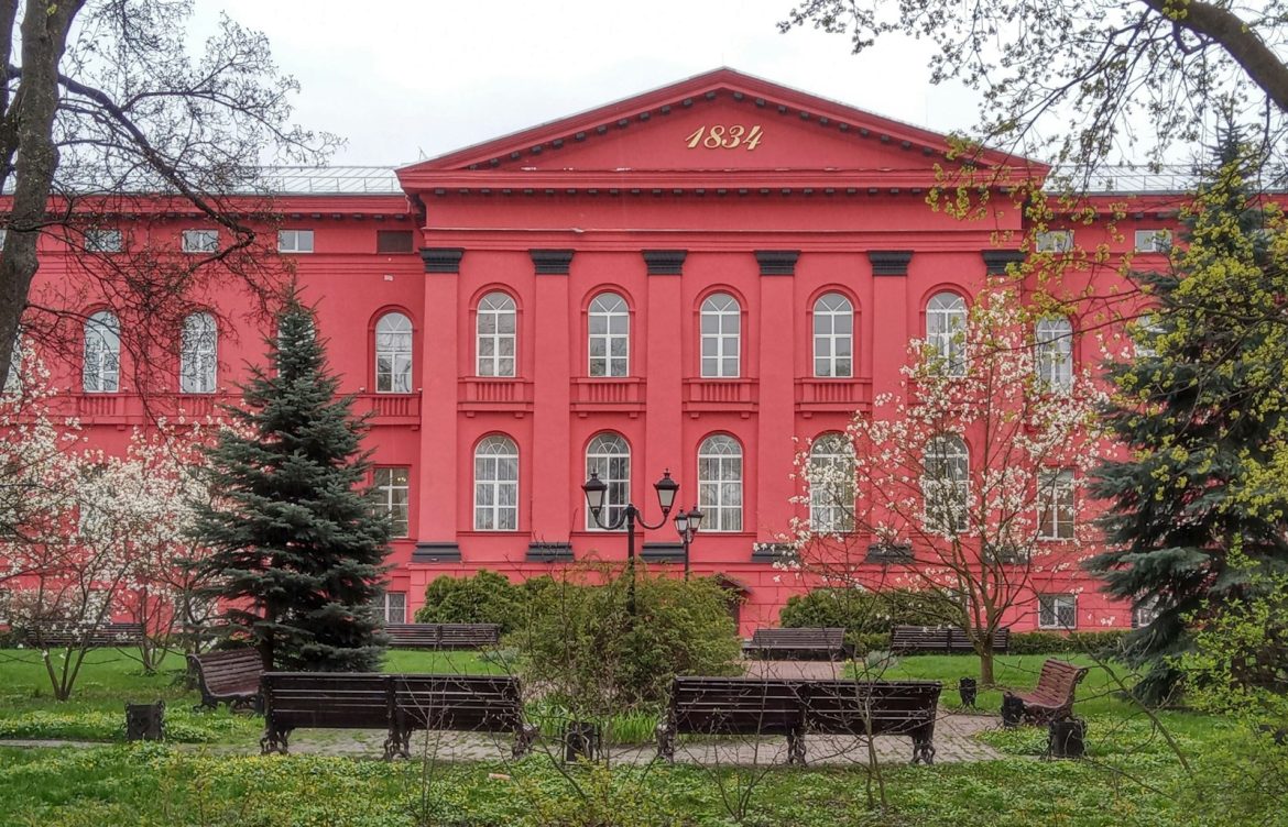 a red building with benches in front of it
